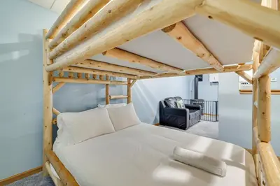 a bedroom with a bed with a wooden bed frame at Secluded Family Cabin with Fire Pit in Lake Ariel! in Lake Ariel
