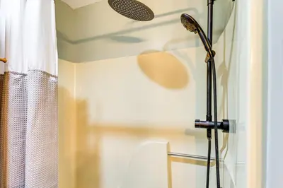 a shower in a bathroom with a shower curtain at Secluded Family Cabin with Fire Pit in Lake Ariel! in Lake Ariel
