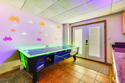 a purple room with a pool table in it at Secluded Family Cabin with Fire Pit in Lake Ariel! in Lake Ariel