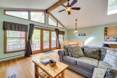 a living room with a couch and a table at Secluded Family Cabin with Fire Pit in Lake Ariel! in Lake Ariel