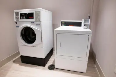 a washing machine and a microwave in a room at Holiday Inn Express & Suites Jersey City - Holland Tunnel by IHG in Jersey City
