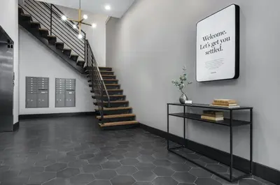 a hallway with a staircase and a table in a room at StayCozy at The Frankford in Philadelphia