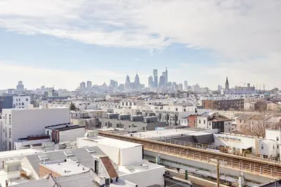 a view of the city from the roof of a building at StayCozy at The Frankford in Philadelphia