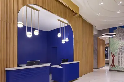 a lobby with two computers on a blue wall at Delta Hotels by Marriott New York Times Square in New York