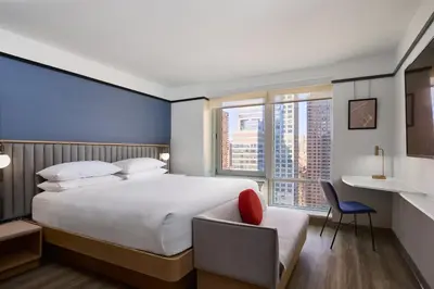 a bedroom with a bed and a desk and a chair at Delta Hotels by Marriott New York Times Square in New York