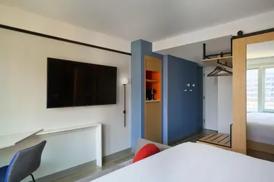 a bedroom with a bed and a tv on a wall at Delta Hotels by Marriott New York Times Square in New York