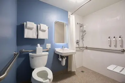 a bathroom with a white toilet and a sink at Delta Hotels by Marriott New York Times Square in New York