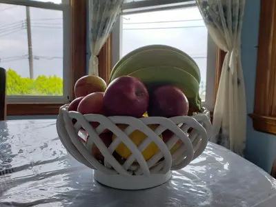 a bowl of fruit sitting on a table at Harbor House Bed and Breakfast in Staten Island