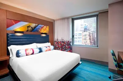 a hotel room with a bed and a window at Aloft Manhattan Downtown - Financial District in New York