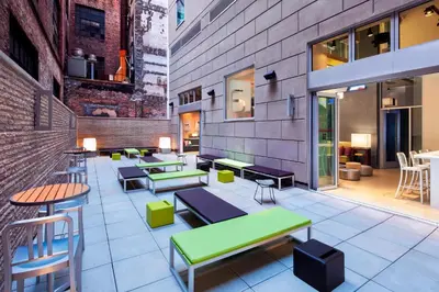 a restaurant with tables and benches in a building at Aloft Manhattan Downtown - Financial District in New York