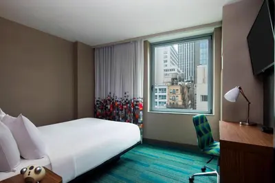 a hotel room with a large bed and a window at Aloft Manhattan Downtown - Financial District in New York