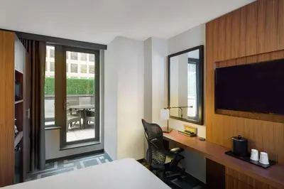 a hotel room with a bed and a desk with a television at Hilton Garden Inn New York Central Park South-Midtown West in New York