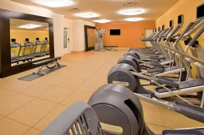 a row of exercise machines in a gym at Hilton Garden Inn New York Central Park South-Midtown West in New York