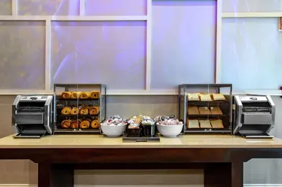 a counter with a bunch of bread and pastries at Homewood Suites Midtown Manhattan Times Square South in New York