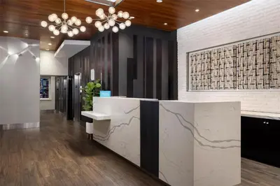 a lobby with a reception desk and a chandelier at Hilton Garden Inn New York - Times Square Central in New York