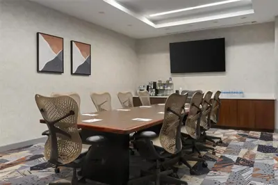 a conference room with a wooden table and chairs at Hilton Garden Inn New York/Midtown Park Avenue in New York