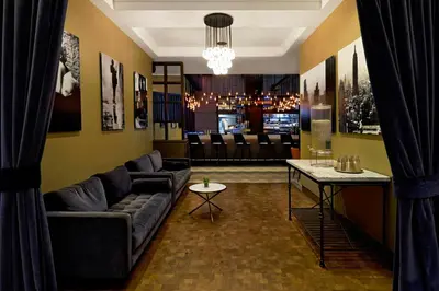a living room with a couch and a table at Archer Hotel New York in New York