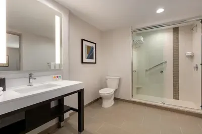a bathroom with a toilet and a sink and a shower at Hyatt Place Fort Lee/George Washington Bridge in Fort Lee