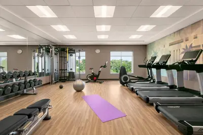 a gym with treadmills and elliptical machines at Hyatt Place Fort Lee/George Washington Bridge in Fort Lee