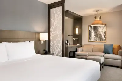 a hotel room with a bed and a couch at Hyatt Place Fort Lee/George Washington Bridge in Fort Lee