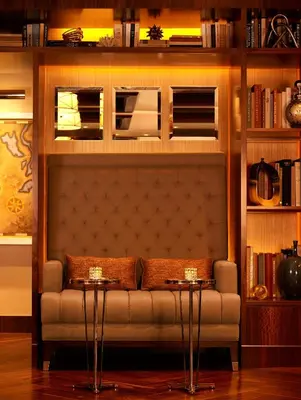 a couch in a living room with two tables at WestHouse Hotel New York in New York