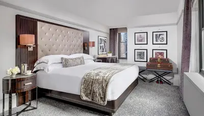 a bedroom with a large bed with a large headboard at WestHouse Hotel New York in New York