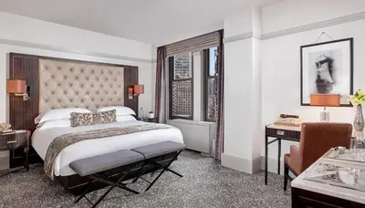 a hotel room with a large bed and a desk at WestHouse Hotel New York in New York