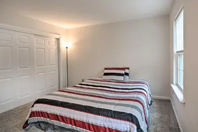 a bedroom with a bed with a striped blanket at Blue Mtn Lake Family House, Steps to Beach! in East Stroudsburg