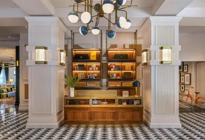 a lobby with two white columns and a chandelier at Canopy By Hilton Philadelphia Center City in Philadelphia