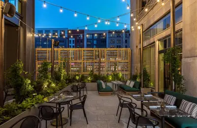 a patio with tables and chairs on a building at Canopy By Hilton Philadelphia Center City in Philadelphia