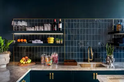 a kitchen with a sink and a blue tiled wall at Canopy By Hilton Philadelphia Center City in Philadelphia