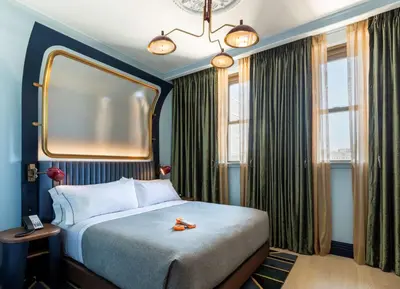 a hotel room with a bed and a mirror at Canopy By Hilton Philadelphia Center City in Philadelphia