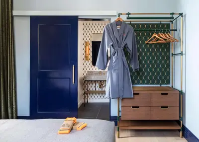 a bedroom with a blue closet with a blue door at Canopy By Hilton Philadelphia Center City in Philadelphia
