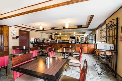 a restaurant with tables and chairs and a bar at Quality Inn & Suites Towanda in Towanda