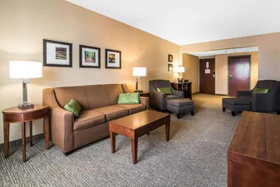 a living room with a couch and chairs in a hotel room at Quality Inn & Suites Towanda in Towanda
