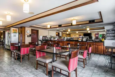 a restaurant with tables and chairs and a bar at Quality Inn & Suites Towanda in Towanda
