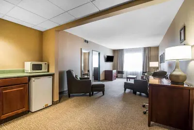 a hotel room with a waiting area with a microwave at Quality Inn & Suites Towanda in Towanda