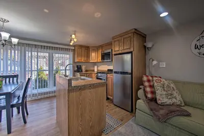 a kitchen and living room with a couch and a refrigerator at Central Hummelstown Apt 4 Miles to Hershey Park! in Hummelstown