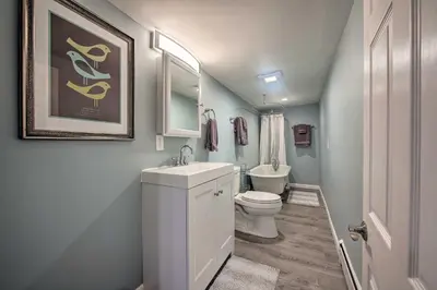 a bathroom with a white toilet and a sink at Central Hummelstown Apt 4 Miles to Hershey Park! in Hummelstown