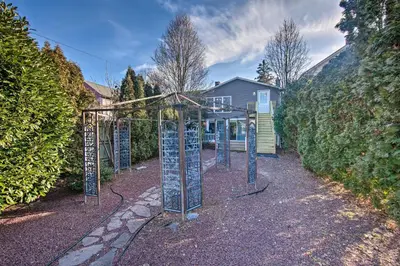 a garden with a metal structure in front of a house at Central Hummelstown Apt 4 Miles to Hershey Park! in Hummelstown