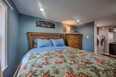 a bedroom with a bed with a floral bedspread at Central Hummelstown Apt 4 Miles to Hershey Park! in Hummelstown