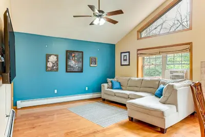 a living room with a couch and a ceiling fan at Resort Amenities and Game Room Arrowhead Lake Home! in Pocono Lake