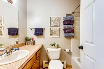 a bathroom with a toilet and a sink at Resort Amenities and Game Room Arrowhead Lake Home! in Pocono Lake