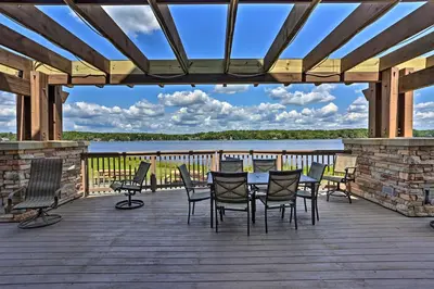 a patio with chairs and a table on a wooden deck at Resort Amenities and Game Room Arrowhead Lake Home! in Pocono Lake