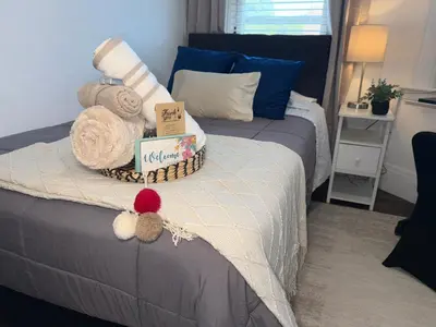 a bedroom with a bed with towels on it at Cozy Private bedrooms Kitchen Wifi in Englewood