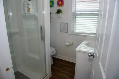 a white bathroom with a shower and a toilet at Cozy Private bedrooms Kitchen Wifi in Englewood