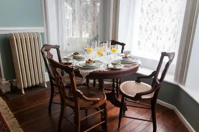 a dining room table with chairs and glasses on it at Gifford-Risley House Bed and Breakfast in Media