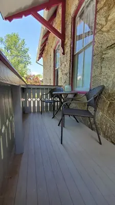 a wooden deck with two benches and a window at Gifford-Risley House Bed and Breakfast in Media