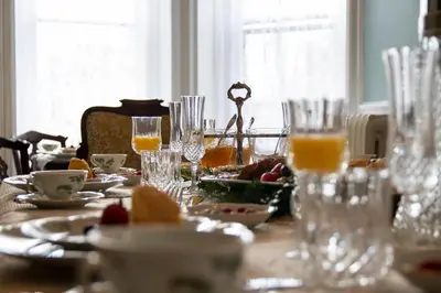 a table with glasses and plates of food on it at Gifford-Risley House Bed and Breakfast in Media