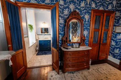 a bathroom with a wooden dresser and a mirror at Gifford-Risley House Bed and Breakfast in Media